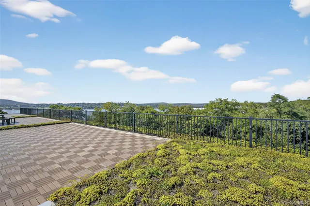 a view of a terrace with couches and city view