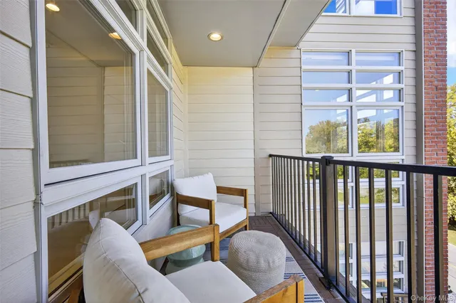 a balcony with table and chairs