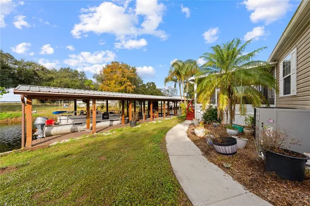 a view of a house with backyard and sitting area