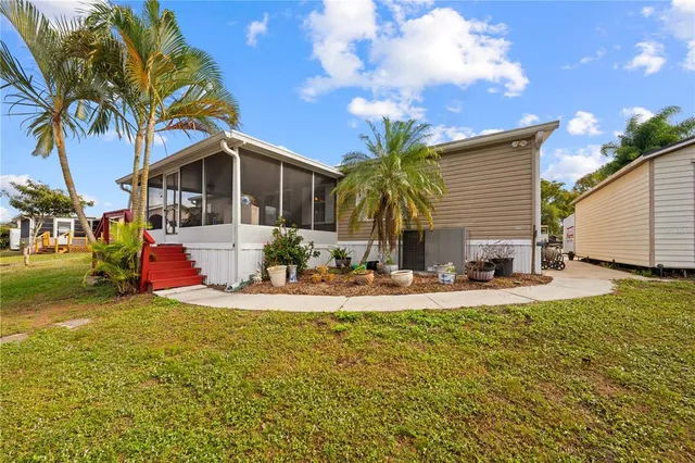 a view of a house with swimming pool and sitting area