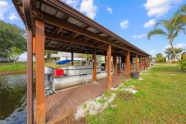 a view of a swimming pool with a patio and a yard