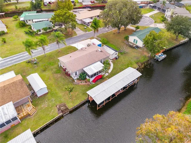 an aerial view of a houses with swimming pool