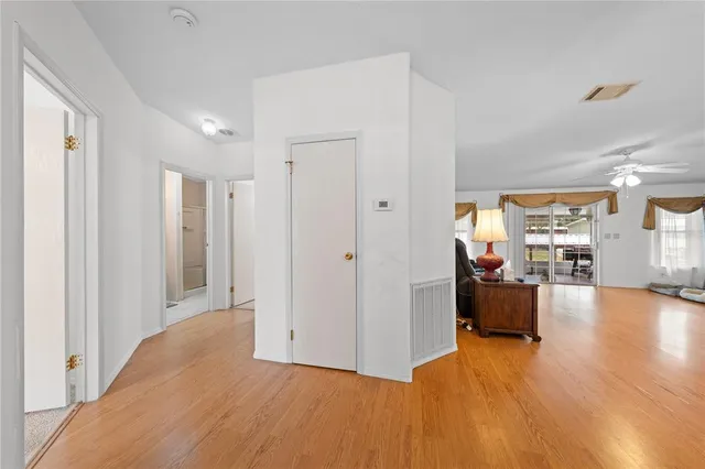a view of a living room hardwood floor and a kitchen