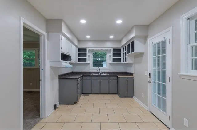 a kitchen with stainless steel appliances granite countertop a refrigerator and a sink