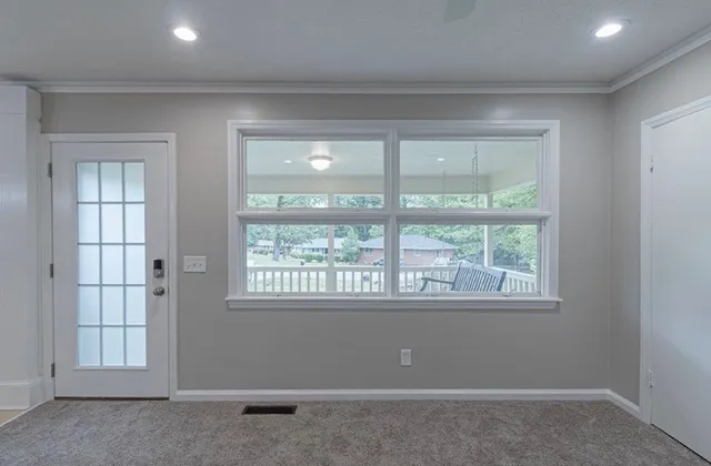 an empty room with windows and closet