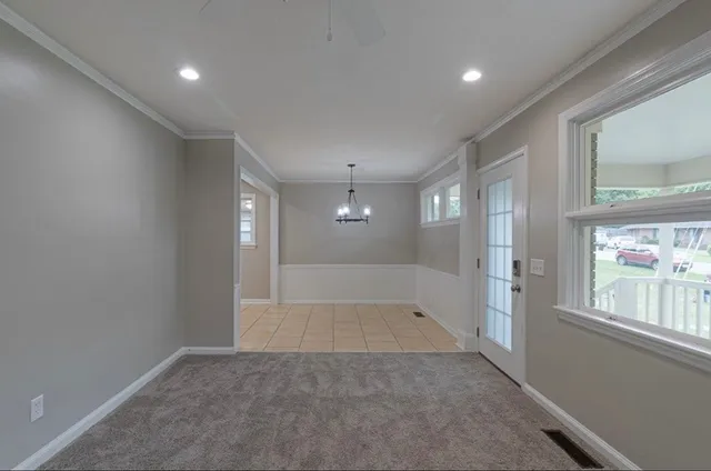 an empty room with windows and entrance