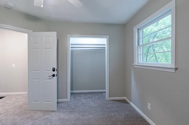 an empty room with windows and closet