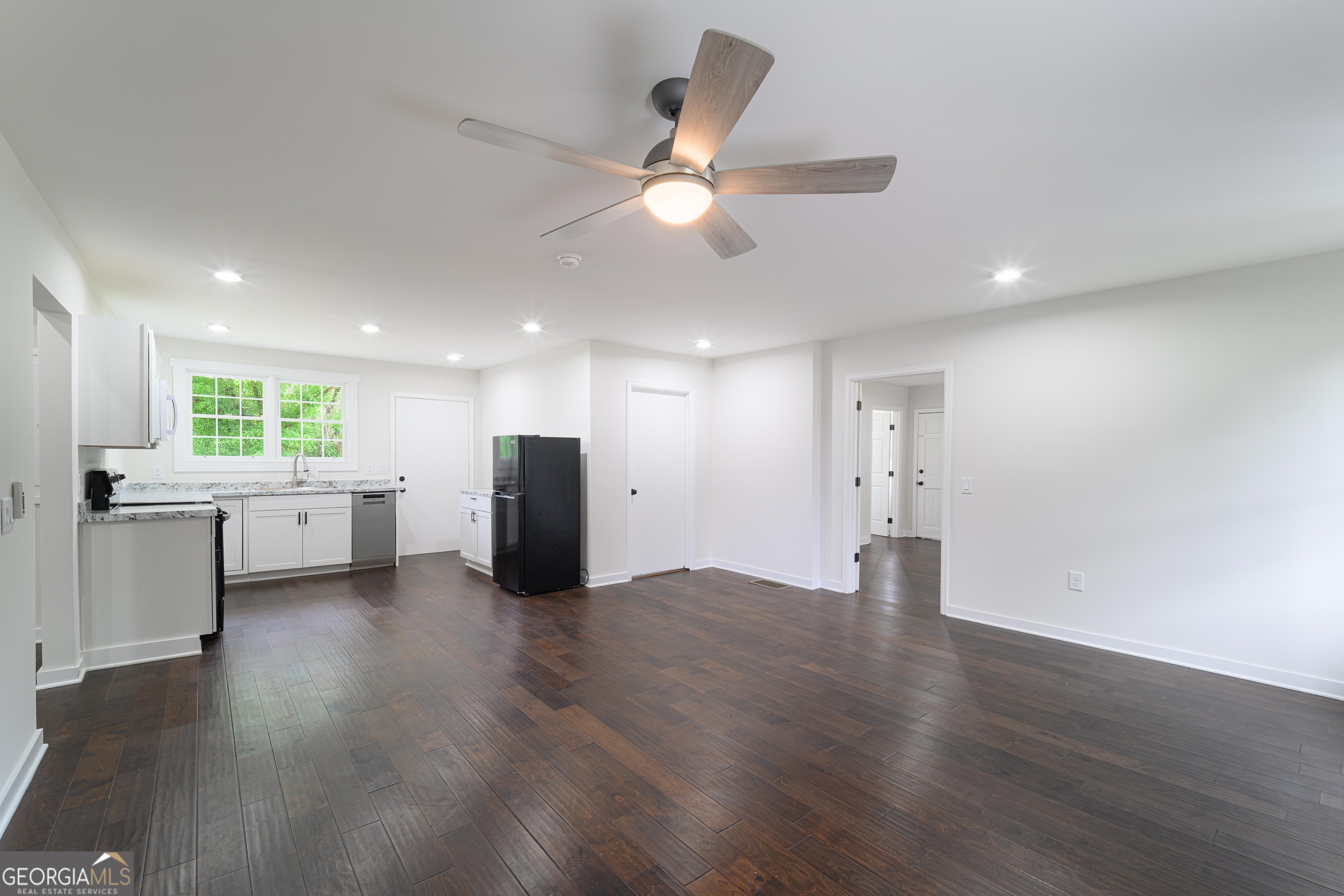 418 Lamb Road Moreland, GA 30259 - Photo 8 of 32 a view of an empty room with a window and wooden floor