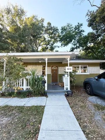 a view of a house with a backyard