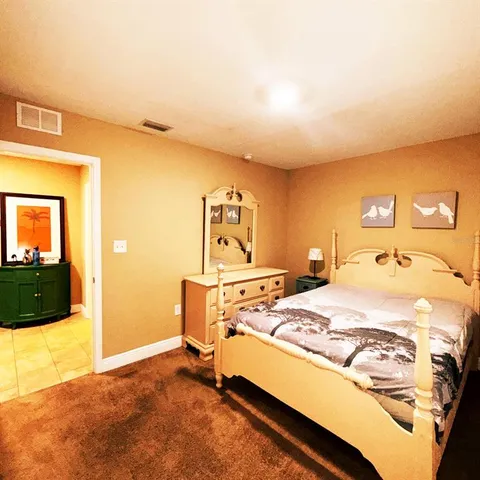 a bed sitting in a bedroom next to a window