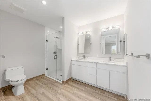 a bathroom with a shower sink and mirror