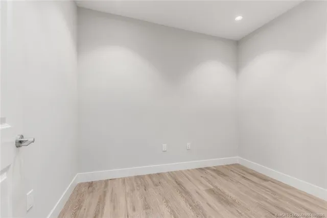 a bathroom with a granite countertop toilet a sink and a mirror