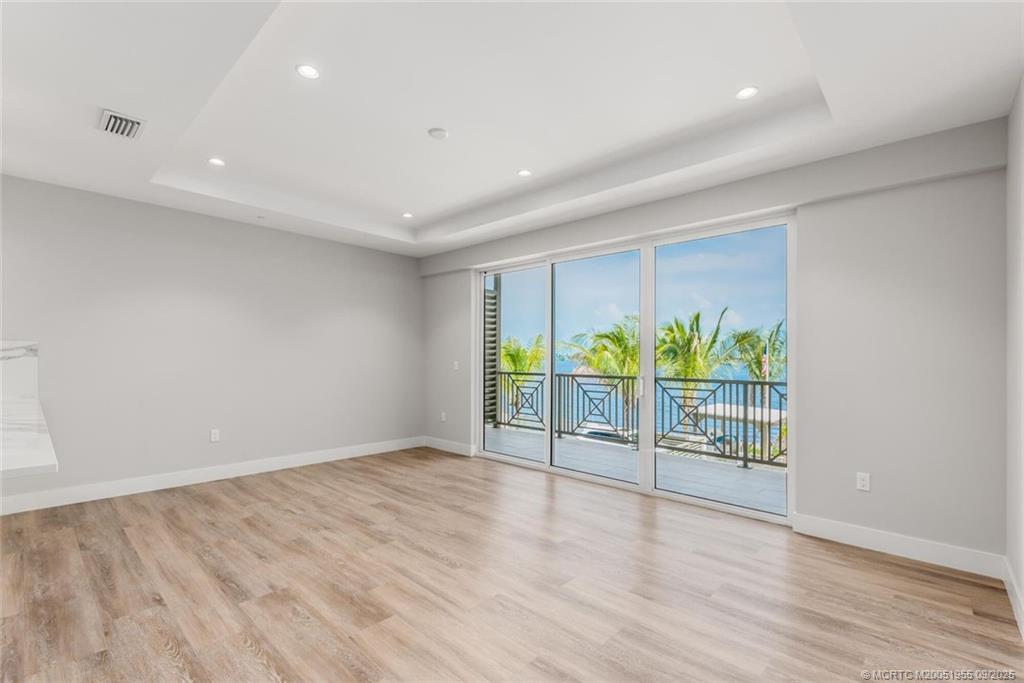41 Southwest Seminole Street, Unit 203 Stuart, FL 34994 - Photo 4 of 20 a view of an empty room with wooden floor