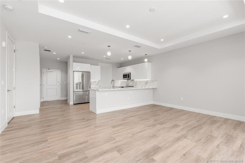 41 Southwest Seminole Street, Unit 203 Stuart, FL 34994 - Photo 8 of 20 a view of kitchen with wooden floor