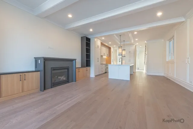 a view of an empty room and a fireplace