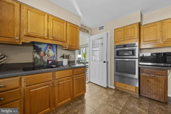 a kitchen with stainless steel appliances granite countertop a refrigerator and cabinets