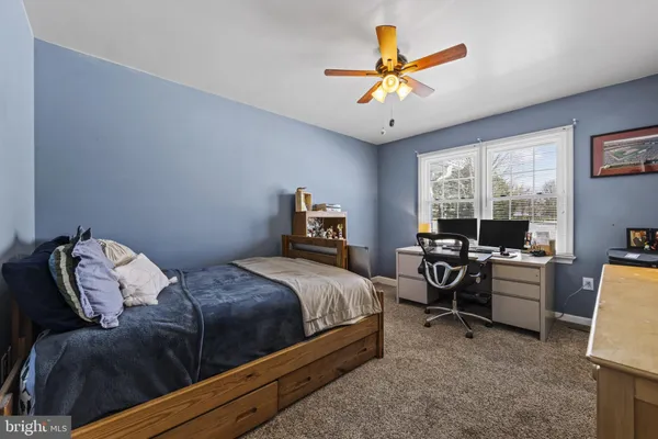 a bedroom with bed and a window