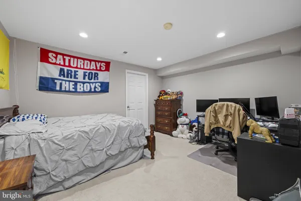 a bedroom with bed and a view of bedroom