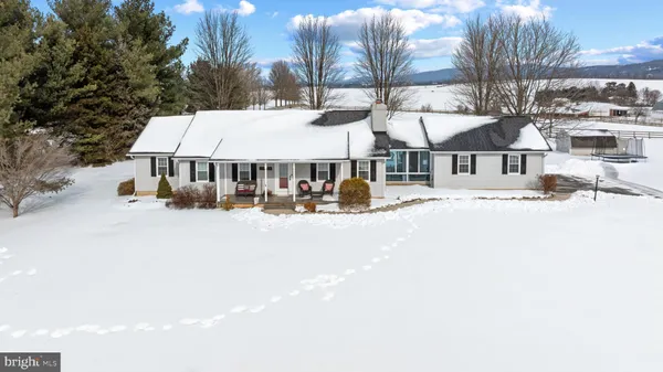 a view of residential houses with yard and road