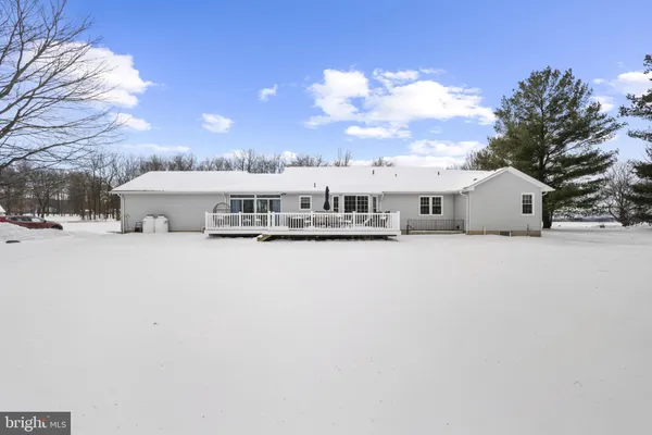 a view of a white house with a snow in front of it