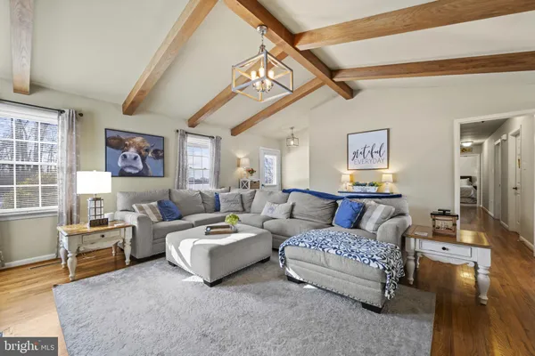 a living room with couches and a flat screen tv