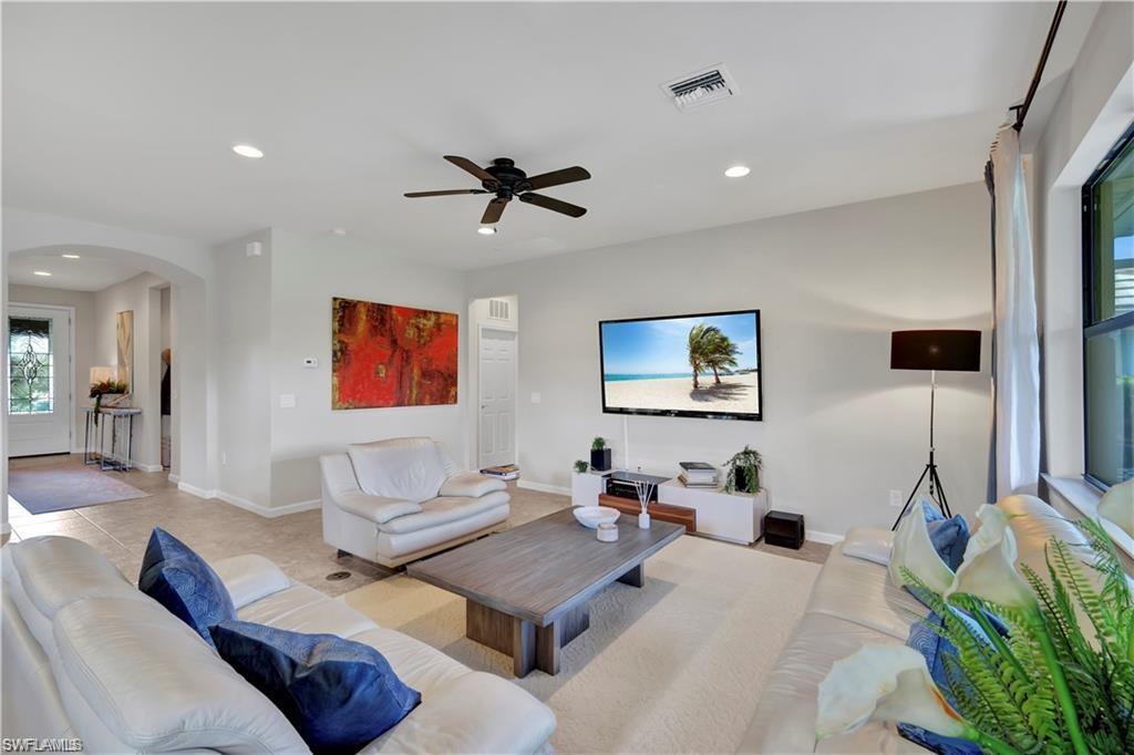 7103 Lily Way Naples, FL 34114 - Photo 11 of 41 a living room with furniture and a flat screen tv
