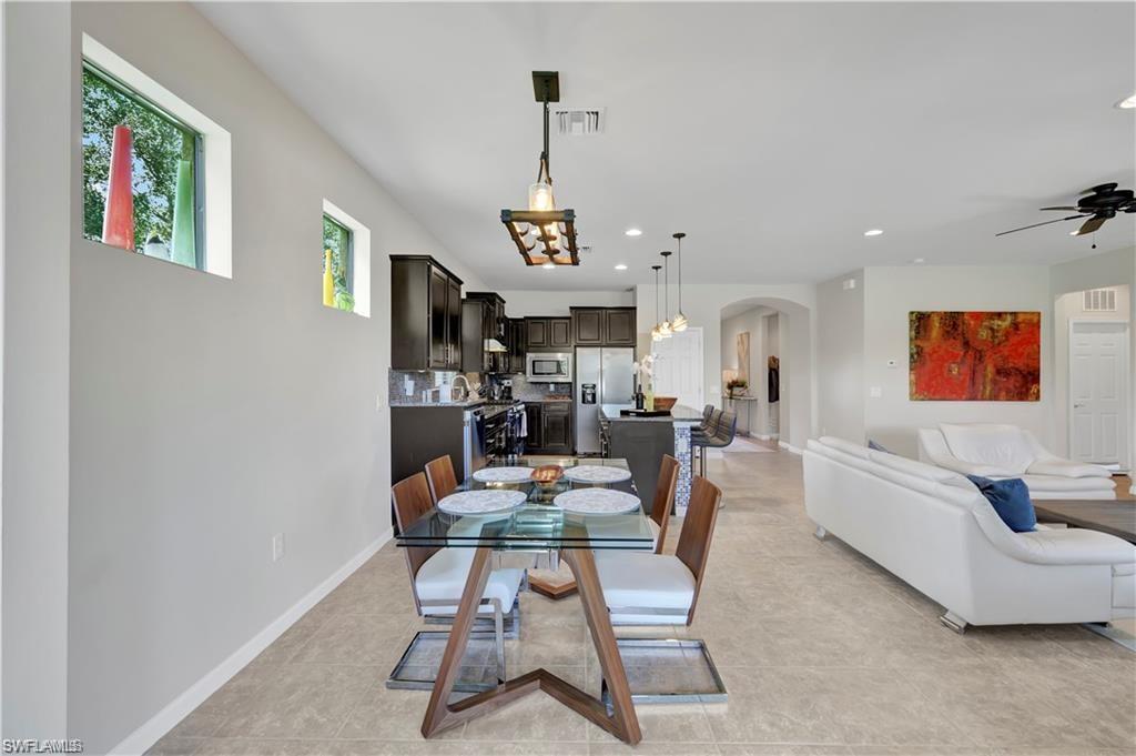 7103 Lily Way Naples, FL 34114 - Photo 13 of 41 a living room with furniture and a chandelier