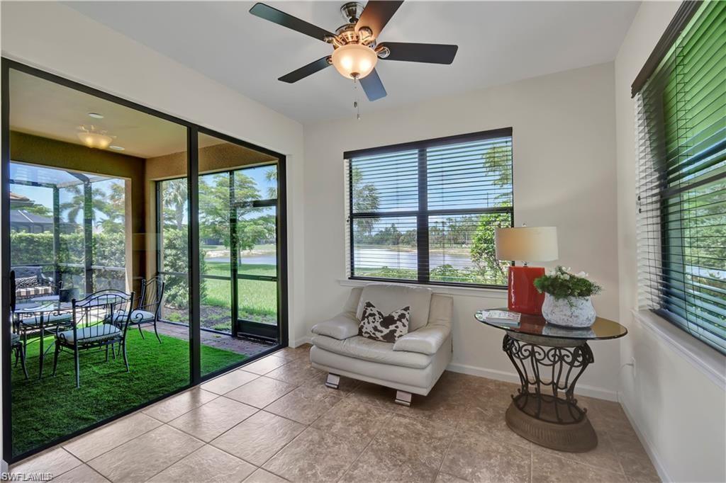 7103 Lily Way Naples, FL 34114 - Photo 14 of 41 a living room with furniture and a floor to ceiling window