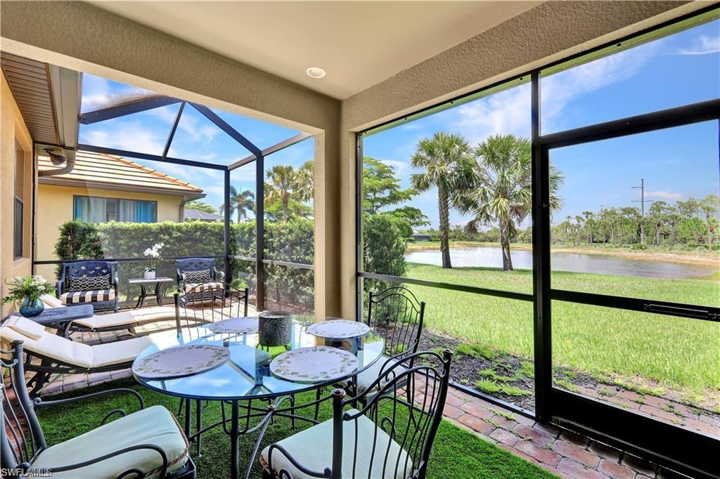 7103 Lily Way Naples, FL 34114 - Photo 15 of 41 a view of a dining room with furniture large windows and wooden floor