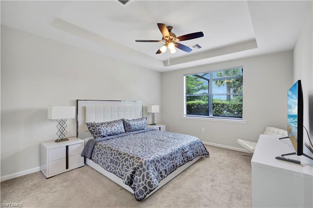 7103 Lily Way Naples, FL 34114 - Photo 19 of 41 a bedroom with a large bed and a window