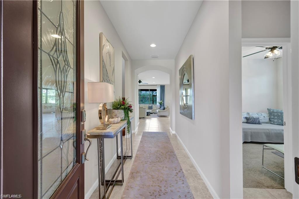 7103 Lily Way Naples, FL 34114 - Photo 2 of 41 a view of a hallway with furniture and floor to ceiling window