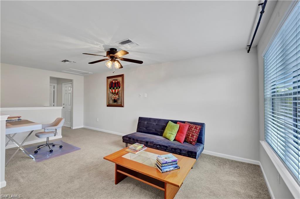 7103 Lily Way Naples, FL 34114 - Photo 22 of 41 a living room with furniture and a window