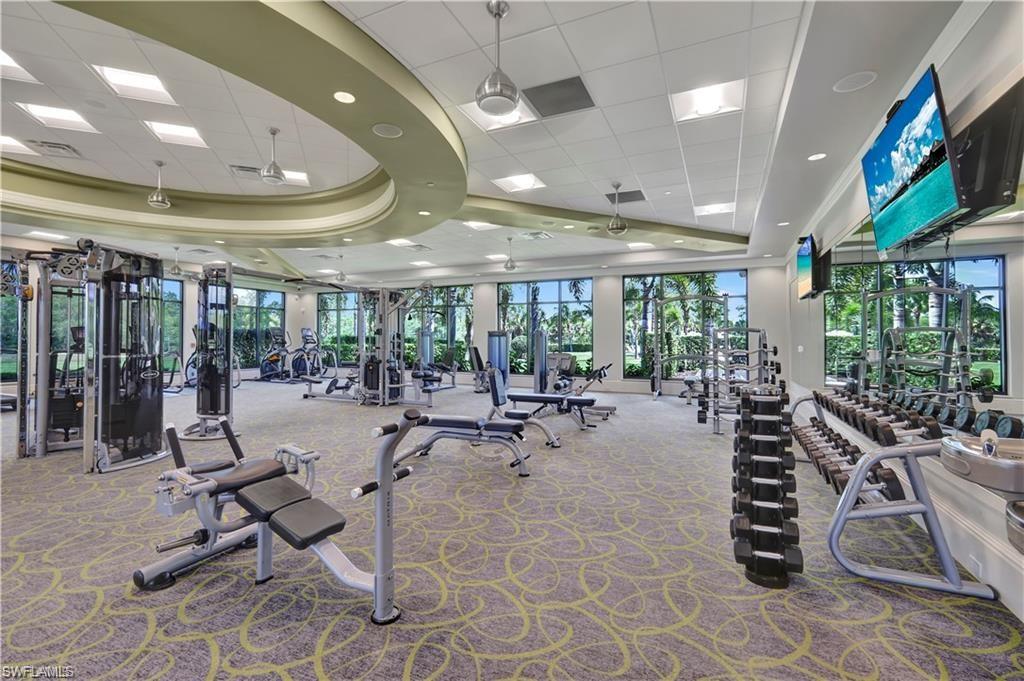 7103 Lily Way Naples, FL 34114 - Photo 32 of 41 a view of a room with gym equipment and large windows