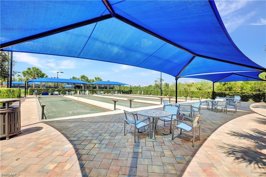 7103 Lily Way Naples, FL 34114 - Photo 37 of 41 a view of a swimming pool with chairs in patio