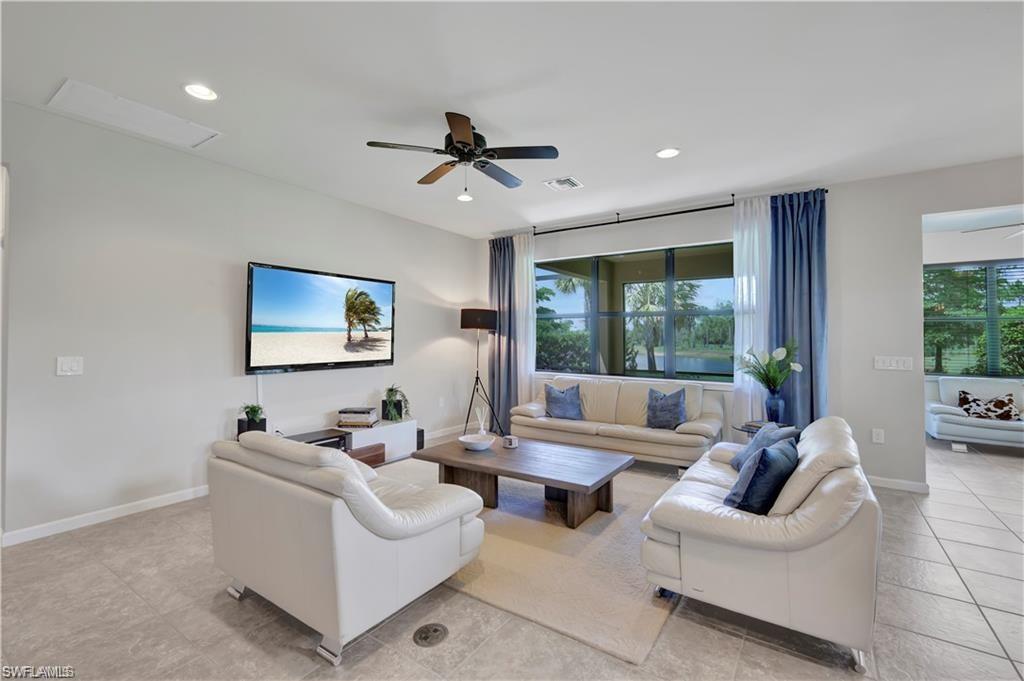 7103 Lily Way Naples, FL 34114 - Photo 8 of 41 a living room with furniture and a large window