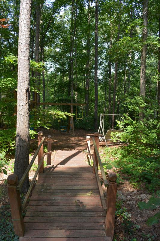3524 Layton Ridge Drive Apex, NC 27539 - Photo 22 of 25 A hand made bridge in the back yard leads to a quite shaded retreat. back yard