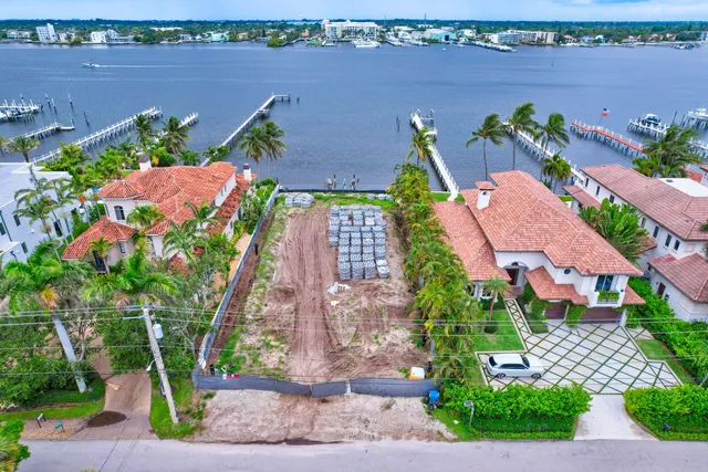 an aerial view of a house with a yard and lake view