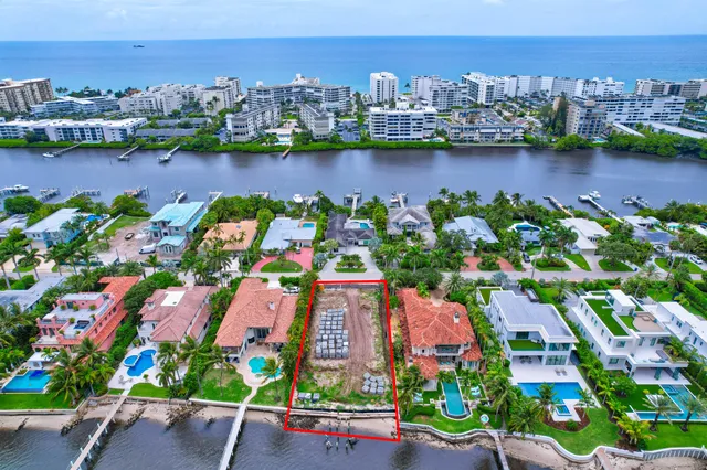 an aerial view of a city with lots of residential buildings lake and ocean view