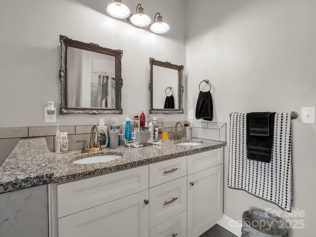 a bathroom with a bathtub and next to a window
