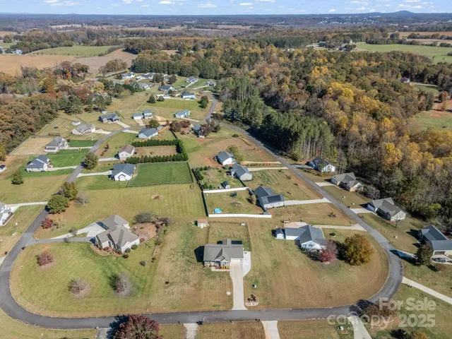 an aerial view of a house with a ocean view