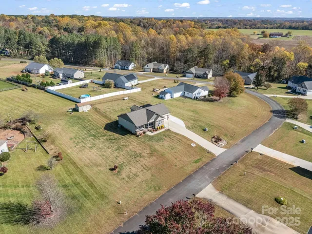 an aerial view of a house with a swimming pool