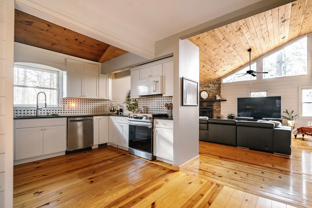 31 Highland Hammock Drive Blue Ridge, GA 30513 - Photo 18 of 67 a kitchen with granite countertop a refrigerator stove top oven and sink