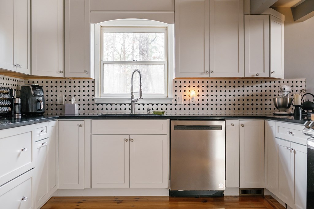 31 Highland Hammock Drive Blue Ridge, GA 30513 - Photo 21 of 67 a kitchen with granite countertop white cabinets and white appliances