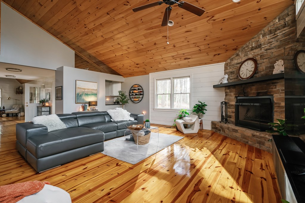 31 Highland Hammock Drive Blue Ridge, GA 30513 - Photo 27 of 67 a living room with furniture a fireplace and a flat screen tv