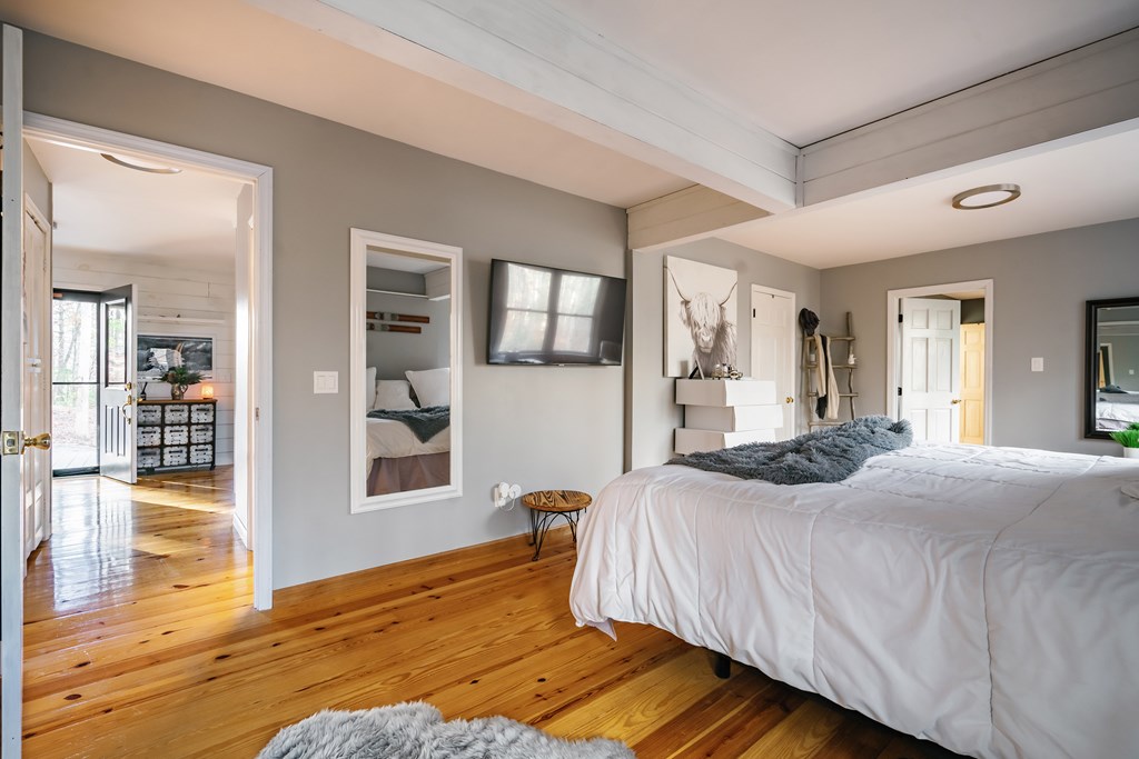 31 Highland Hammock Drive Blue Ridge, GA 30513 - Photo 32 of 67 a bedroom with a bed and wooden floor