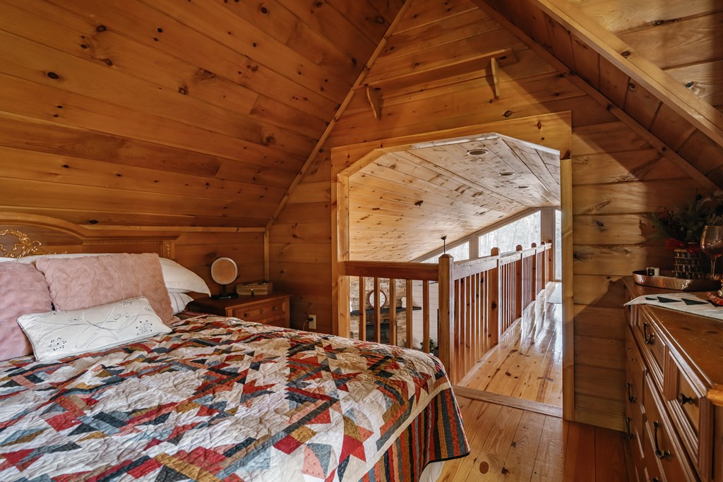 31 Highland Hammock Drive Blue Ridge, GA 30513 - Photo 47 of 67 a bed sitting in a bedroom next to a window