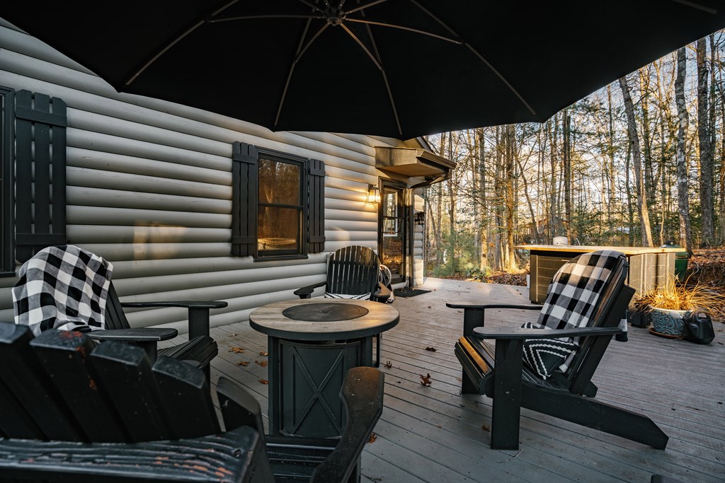 31 Highland Hammock Drive Blue Ridge, GA 30513 - Photo 58 of 67 a view of a patio with table and chairs under an umbrella