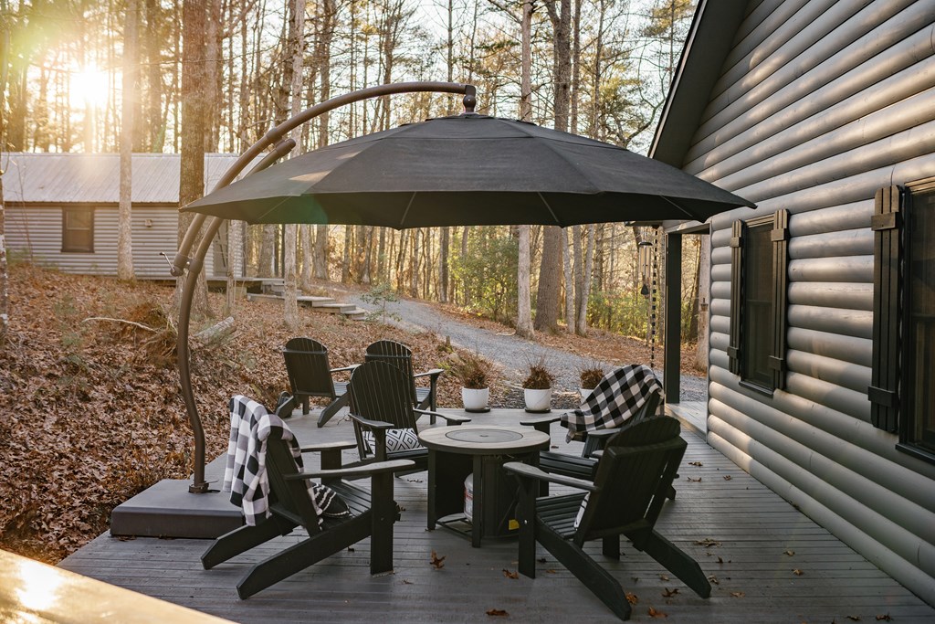 31 Highland Hammock Drive Blue Ridge, GA 30513 - Photo 6 of 67 a view of a patio with table and chairs and wooden floor