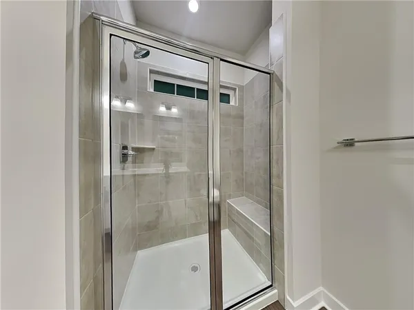 a bathroom with a glass shower door