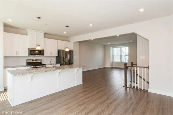 a kitchen with stainless steel appliances a refrigerator sink and microwave
